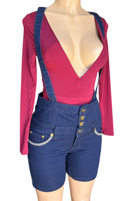 Mannequin wearing a red top and blue denim shorts with suspenders on a white background