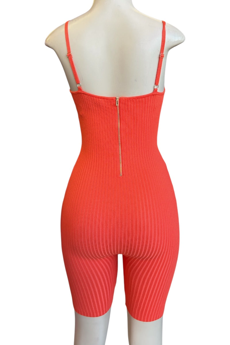 A bright coral orange ribbed knit one-piece jumpsuit with thin shoulder straps and a central zipper, displayed on a white mannequin against a white background.