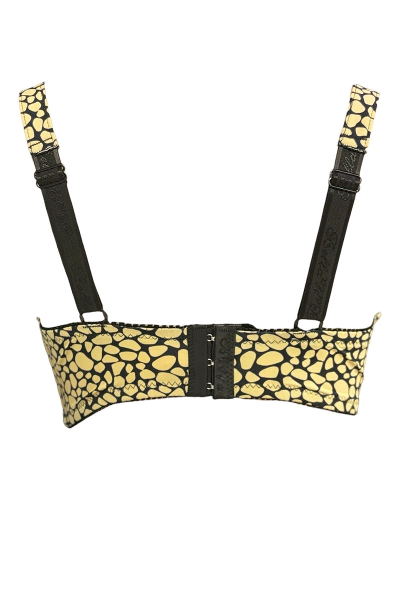 Yellow patterned bra with black straps on a white background