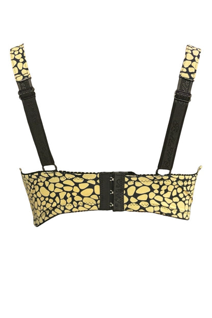 Yellow patterned bra with black straps on a white background