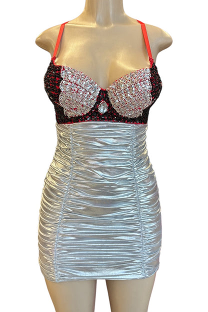 Mannequin wearing a silver dress with a black and red embellished top on a white background