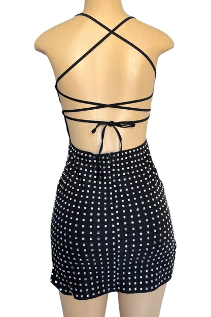 Black rhinestone dress with criss-cross straps on a mannequin against a white background