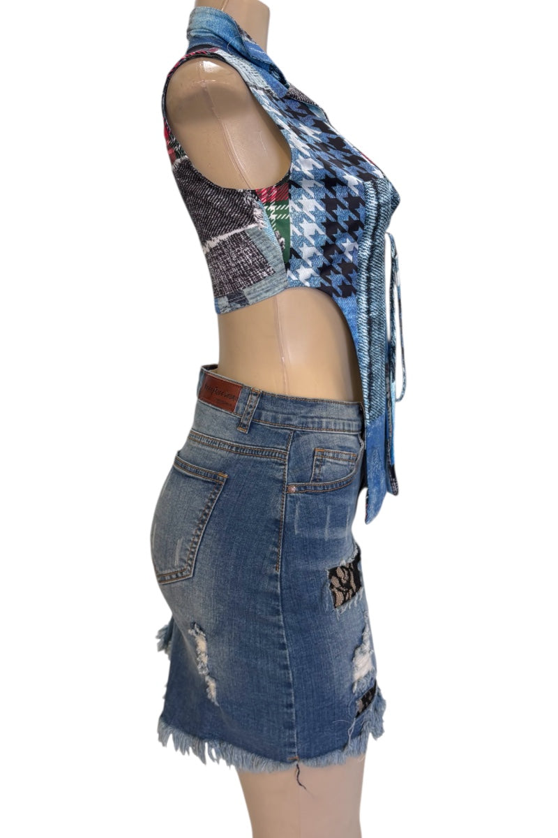 Mannequin wearing a patchwork denim top and denim skirt with a white background