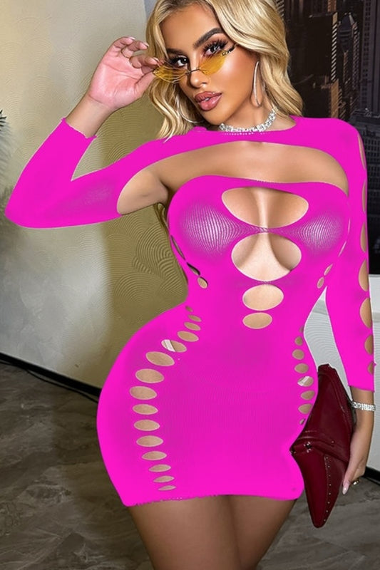 Woman wearing a bright pink dress with cut-out design in an indoor setting.