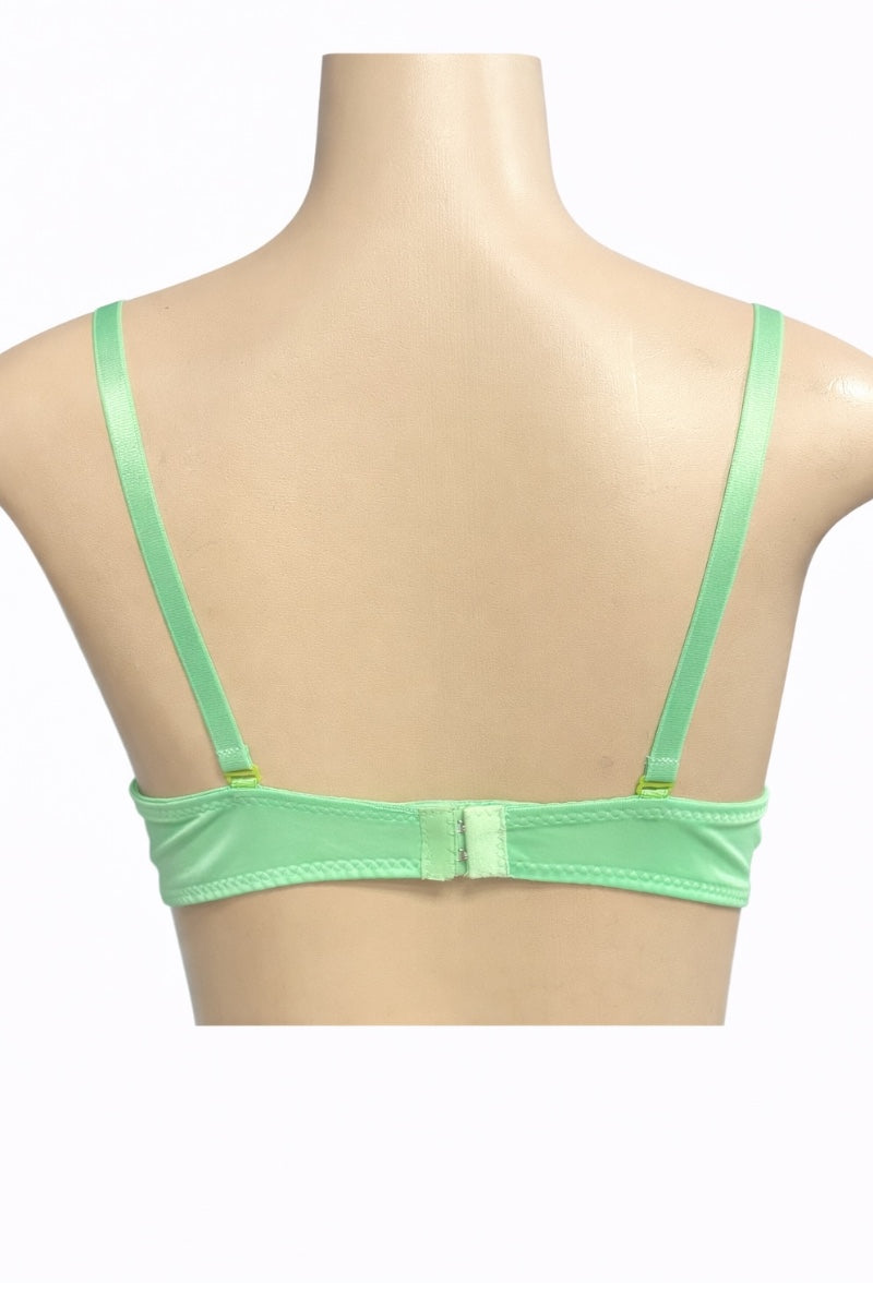 Green bra on a mannequin with a white background
