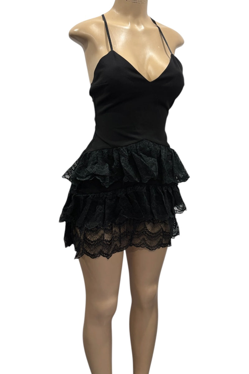 Black lace dress on a mannequin against a white background