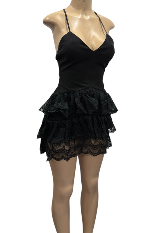 Black lace dress on a mannequin against a white background