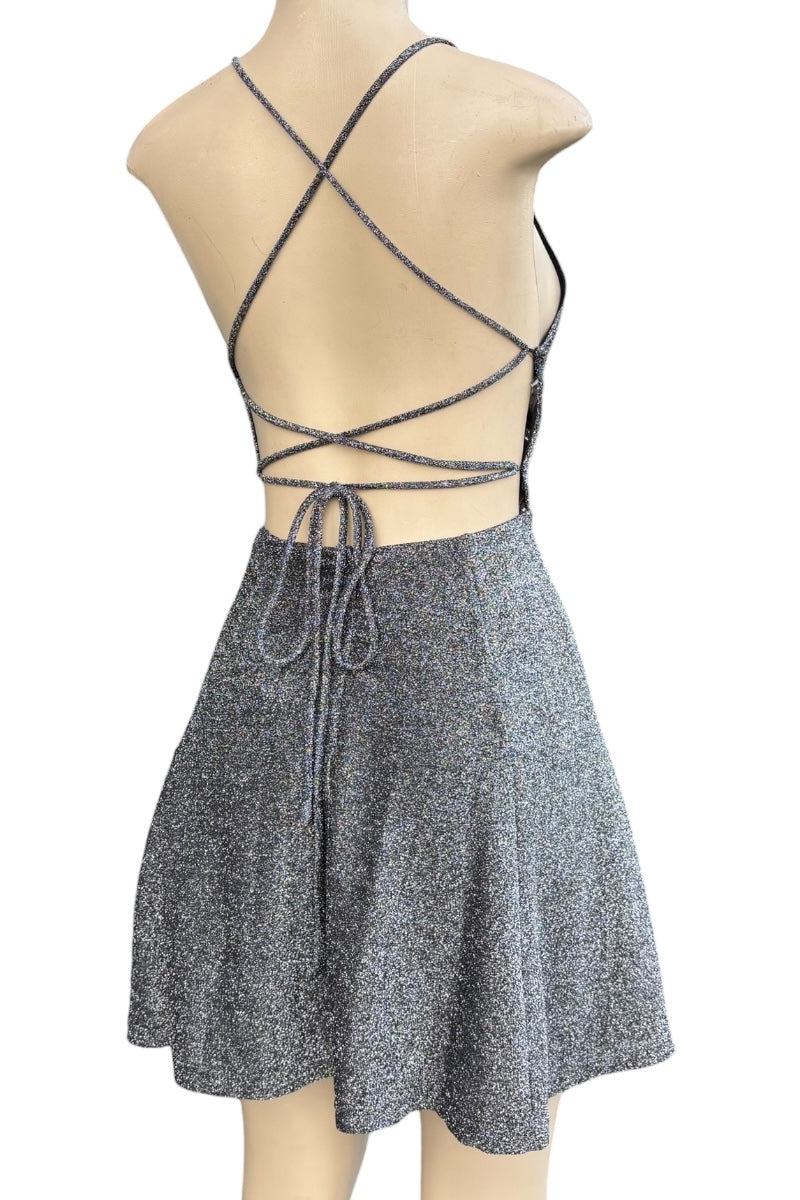 Mannequin wearing a gray dress with criss-cross straps on a white background