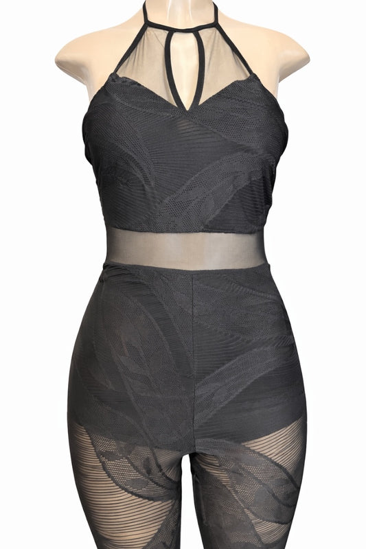 Black sheer jumpsuit on a mannequin against a white background
