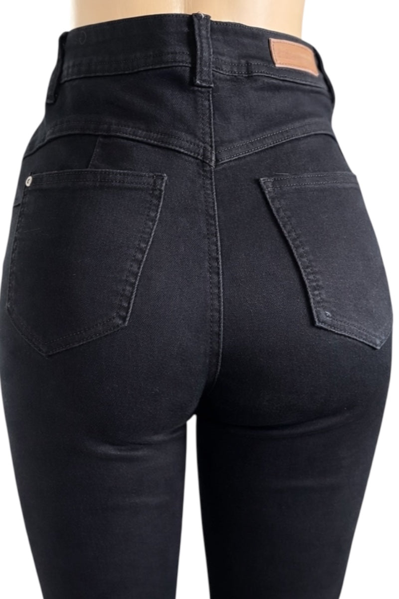 Black jeans being worn, showing the back view with a plain background