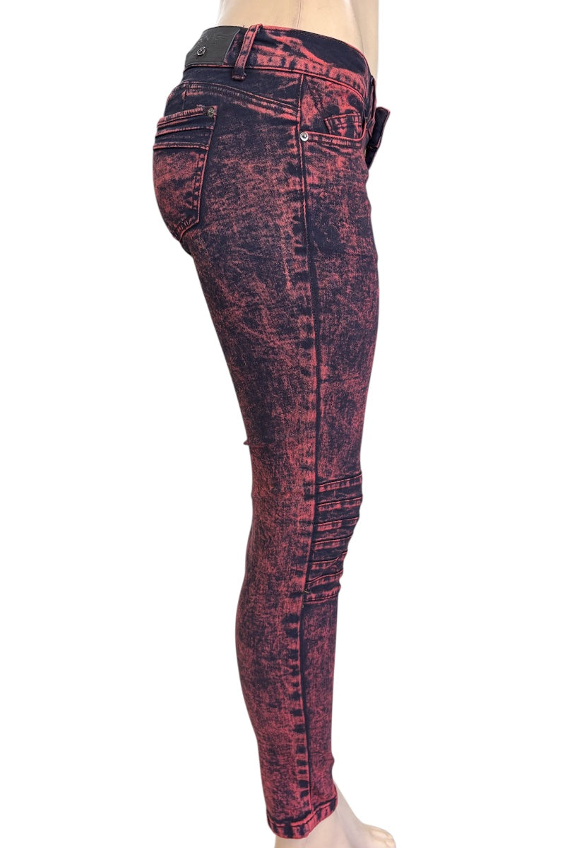 Red and black distressed jeans on a white background