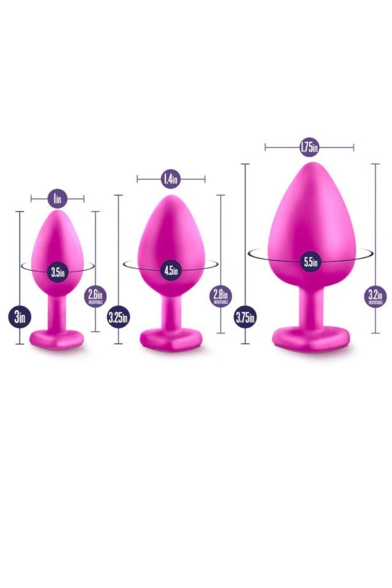 Three pink silicone butt plugs with measurements on a white background