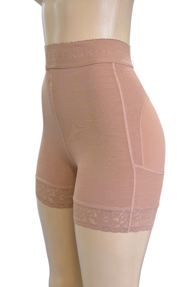 High-waisted shapewear shorts in a beige color, shown on a mannequin from a side profile view against a white background.