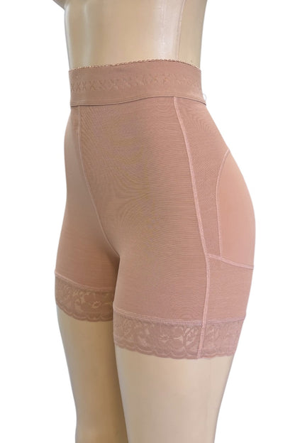 High-waisted shapewear shorts in a beige color, shown on a mannequin from a side profile view against a white background.