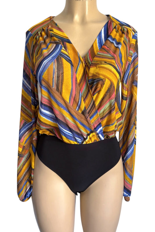 Colorful patterned top with long sleeves and a black bottom on a mannequin against a white background