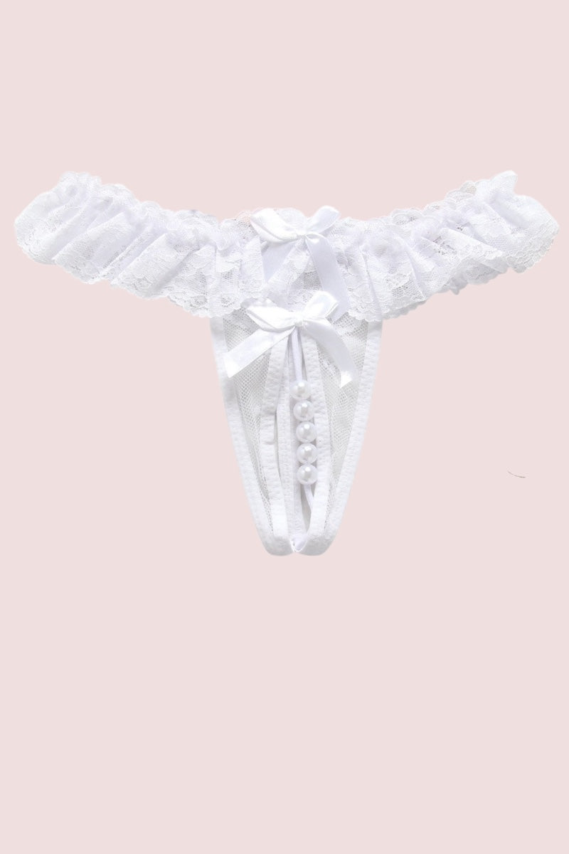 White lace  thong featuring a central bow, pearl-like embellishments displayed against a solid pale pink background.