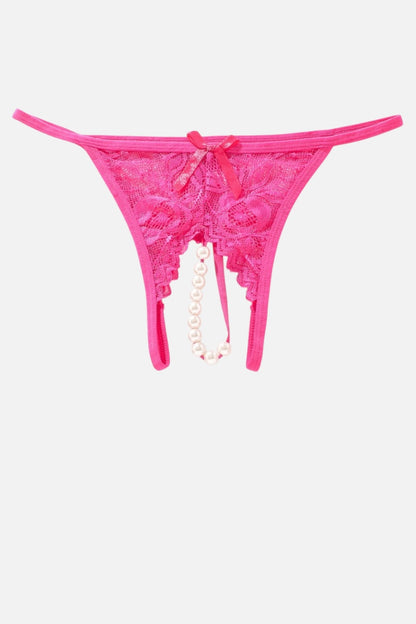 Bright pink lace thong underwear with a small bow at the center front and a dangling pearl bead chain, shown on a plain light gray background.