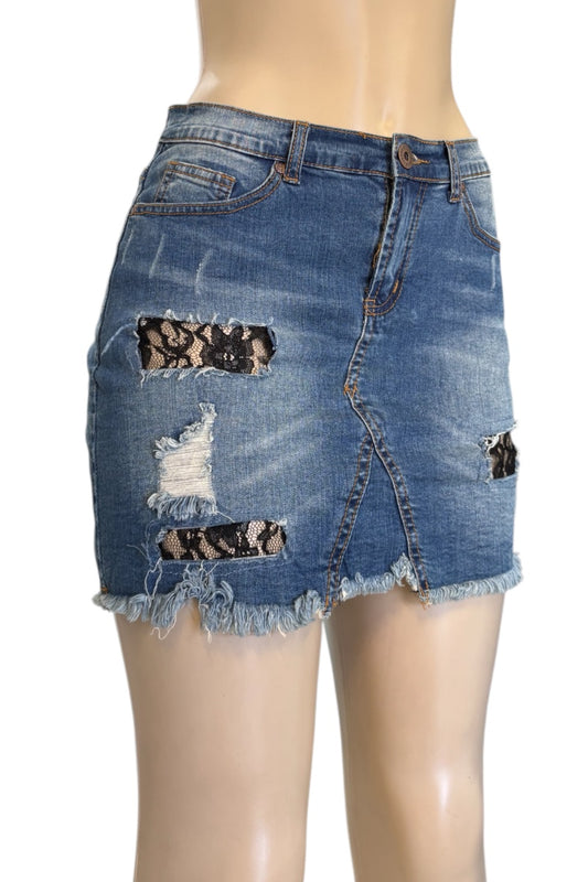 Denim skirt with lace inserts on a mannequin against a white background