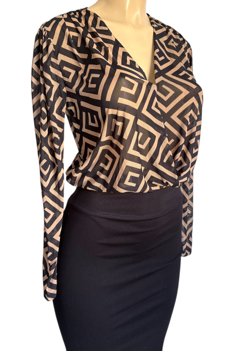 Mannequin wearing a patterned top and black skirt on a white background