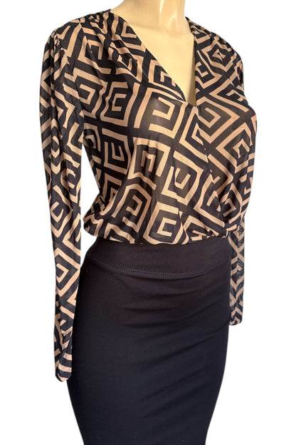 Mannequin wearing a patterned top and black skirt on a white background