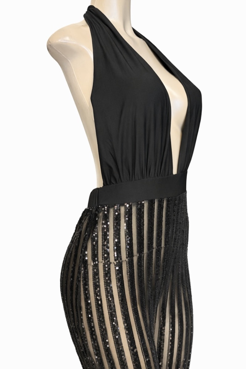 Black halter neck jumpsuit with sheer side panels on a mannequin against a white background