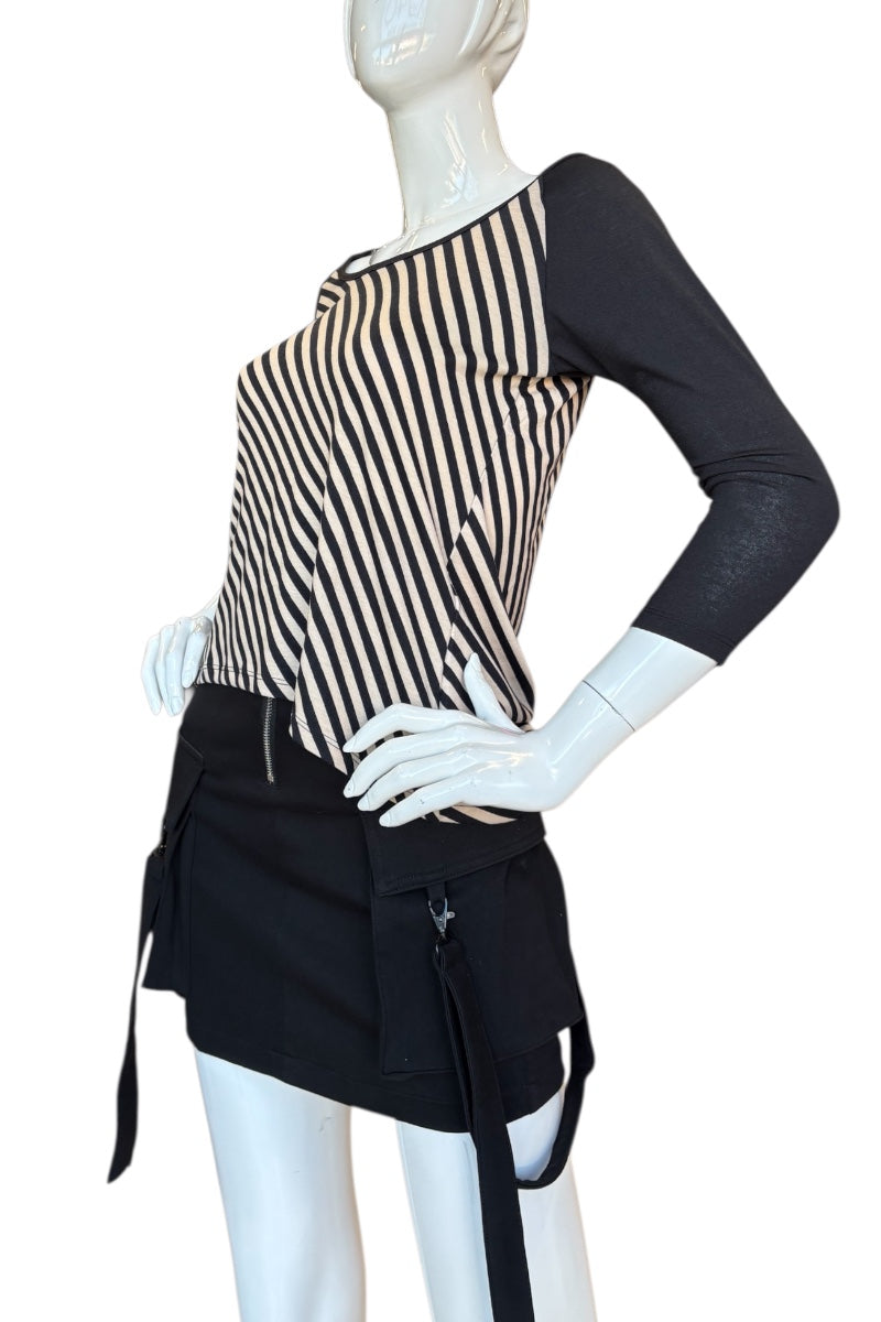 Mannequin wearing a black and beige striped top with a black apron on a white background