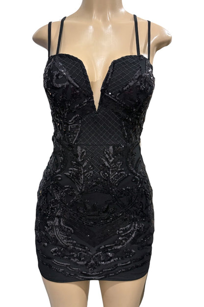 Black sequin dress on a mannequin against a white background