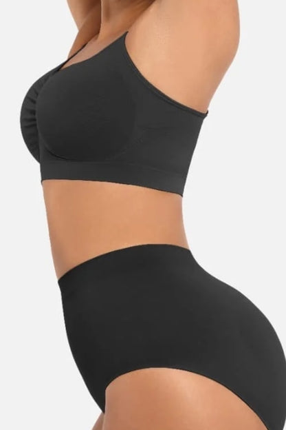Black bralette and high-waisted panties on a plain background