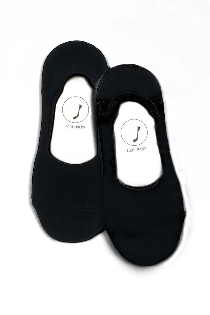 Black liner socks on a white background