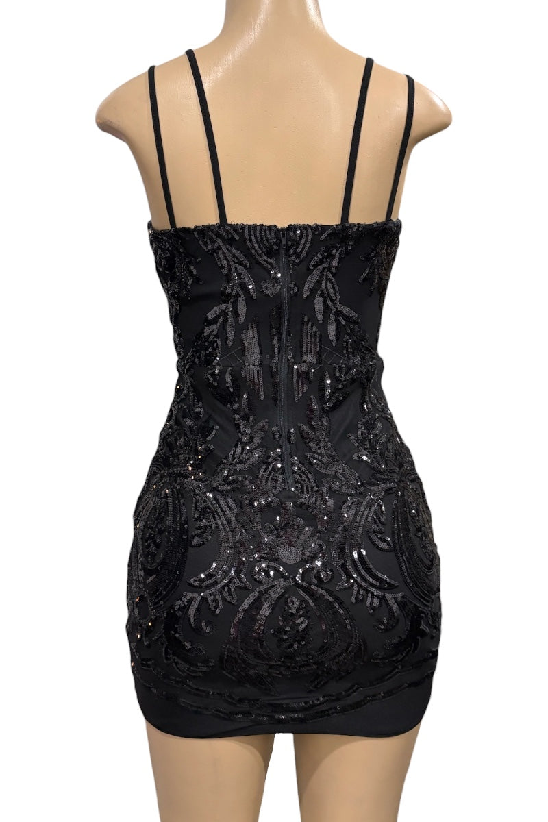 Black sequin dress on a mannequin against a white background