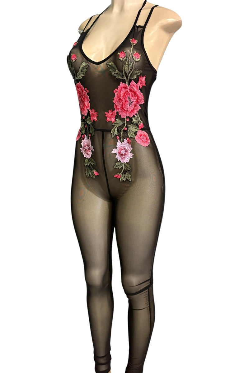A sheer black bodysuit with pink and red floral embroidery and green leaves, displayed on a mannequin against a white background.