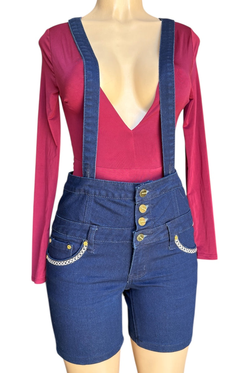 Mannequin wearing a red long-sleeve top and blue denim overalls with gold buttons on a white background