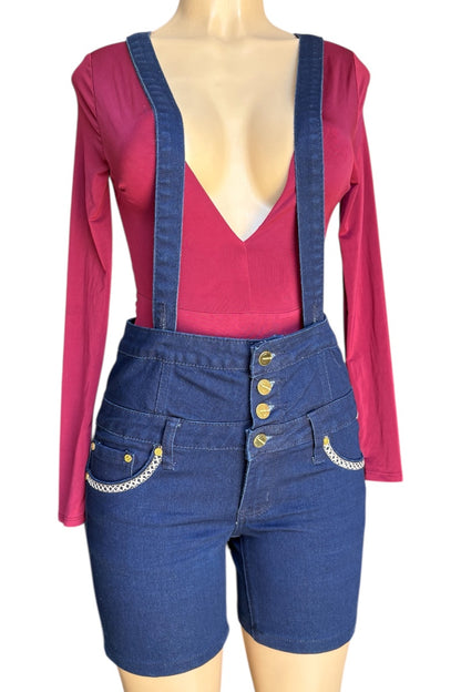 Mannequin wearing a red long-sleeve top and blue denim overalls with gold buttons on a white background
