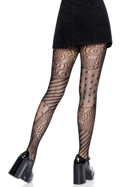 Black patterned tights with spiral and polka-dot motifs, shown on a model from the waist down wearing a black skirt and black high-heeled shoes against a white background.