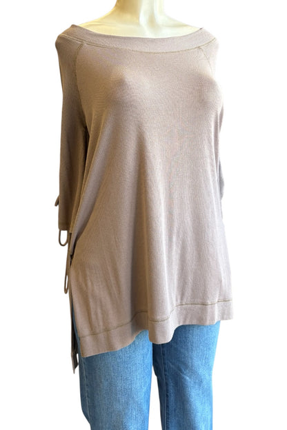 A taupe knit top with a wide boat neckline and side tie details, displayed on a mannequin torso paired with blue jeans against a white background.