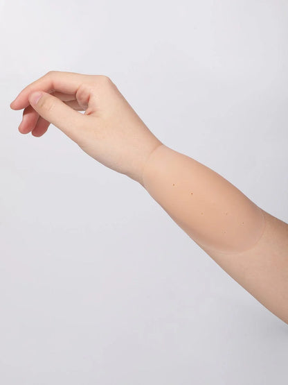 Partial view of a person's arm and hand on a light gray background