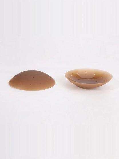 Two brown silicone pasties on a white background
