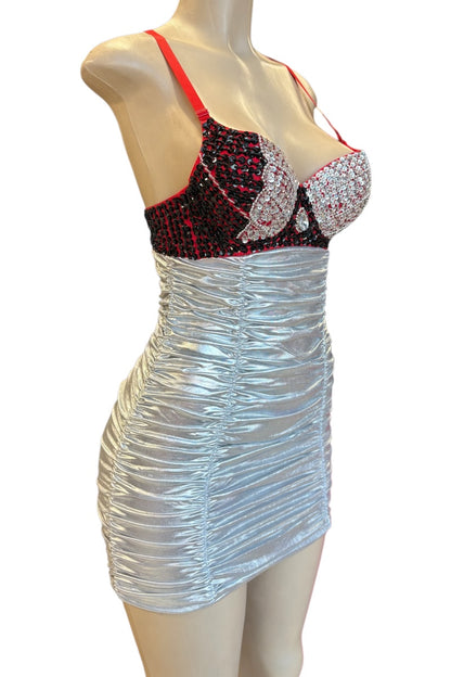 Mannequin wearing a silver dress with a red and black embellished top on a white background