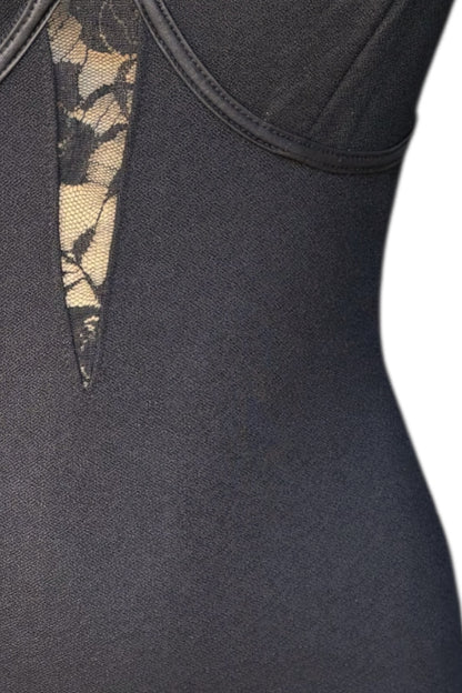 Close up of black dress with lace detailing on a white background