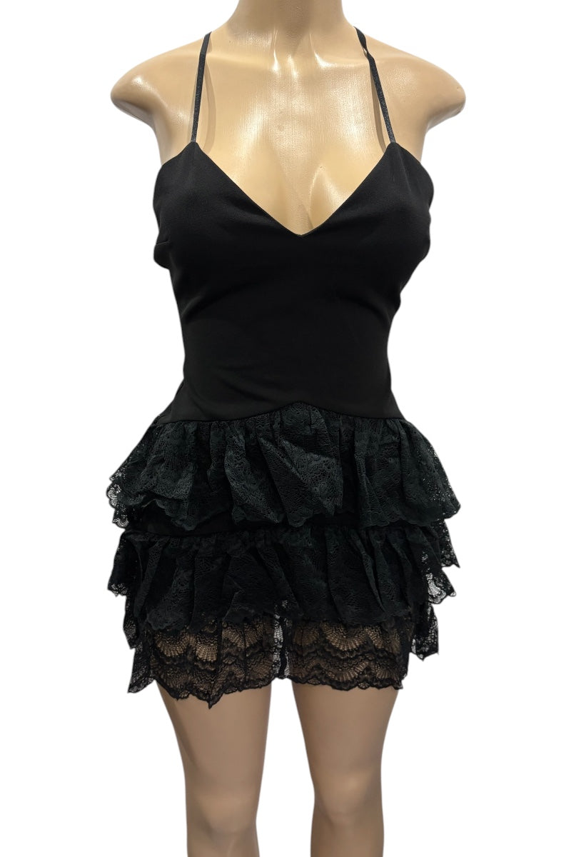 Black lace dress on a mannequin against a white background