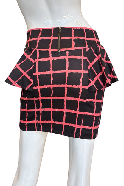 A black and red plaid mini skirt with a ruffled waistband displayed on a white mannequin.