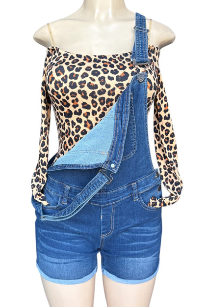 Mannequin wearing a leopard print top and blue denim overalls on a white background