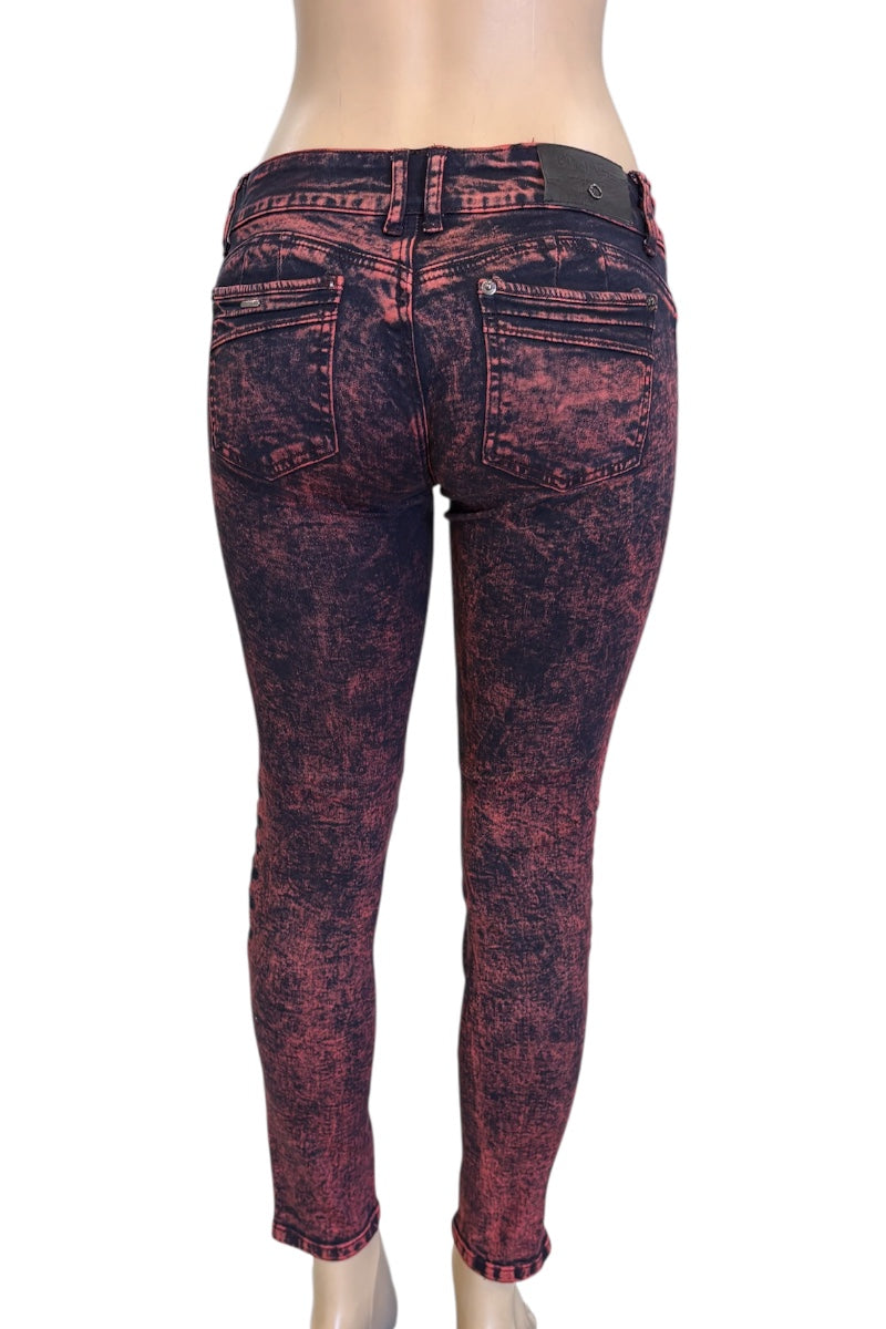Red and black distressed jeans on a mannequin with a white background