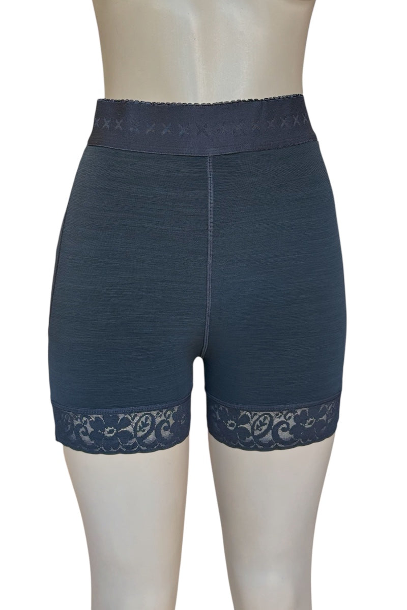 Black high-waisted compression shorts with lace trim at the hem and waistband, displayed on a mannequin.