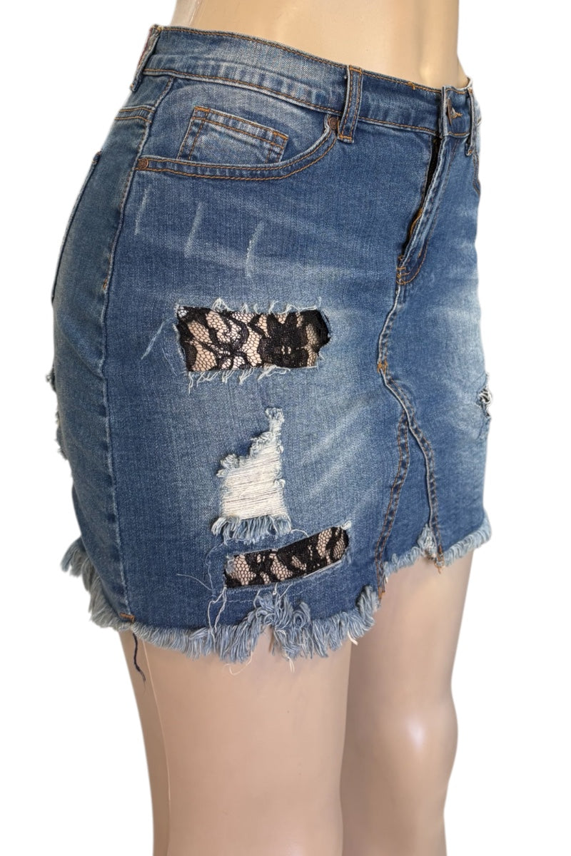 Ripped denim skirt with lace patches on a white background