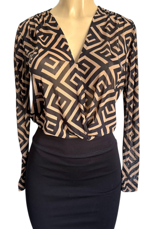 Mannequin wearing a patterned top and black skirt on a white background