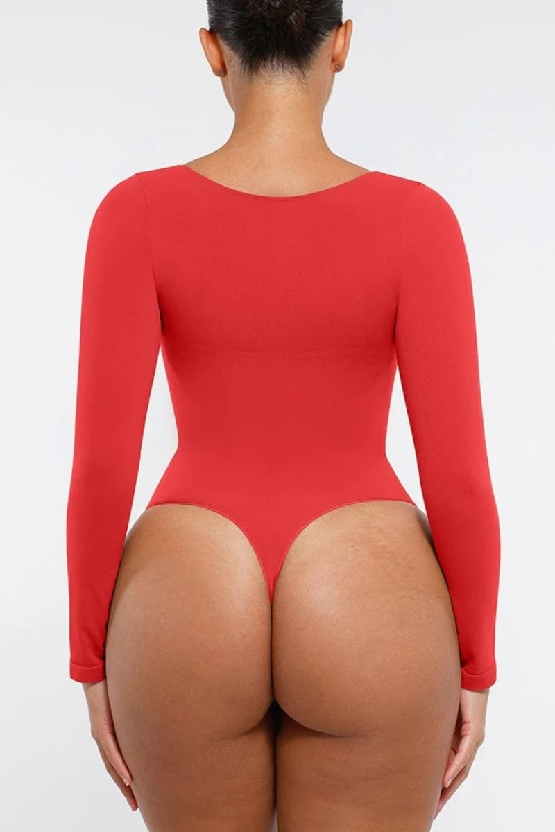 Person wearing a red bodysuit on a white background
