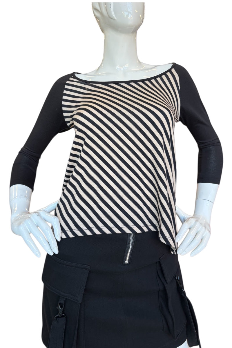 Mannequin wearing a black and beige striped top with a black skirt on a white background