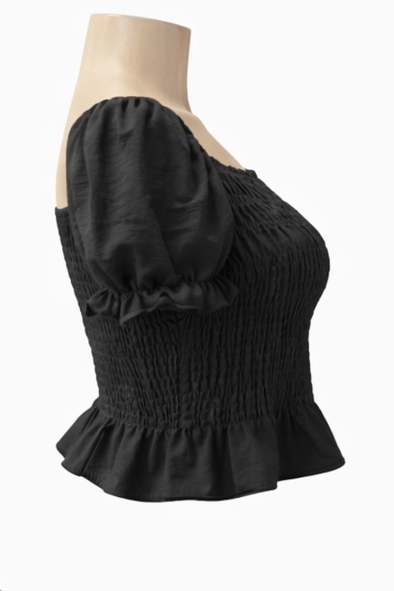 Black off-shoulder top on a mannequin against a white background