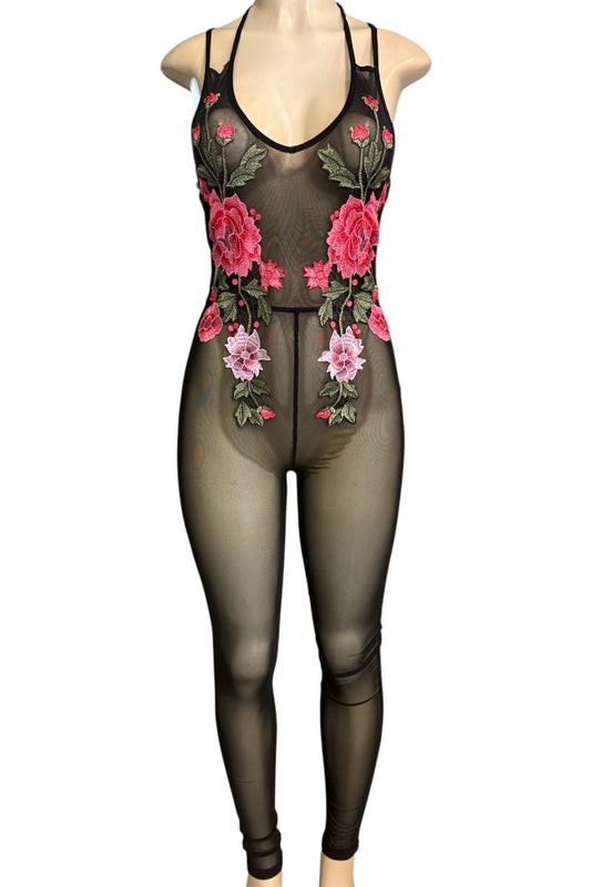A sheer black bodysuit with pink and red floral embroidery and green leaves, displayed on a mannequin against a white background.